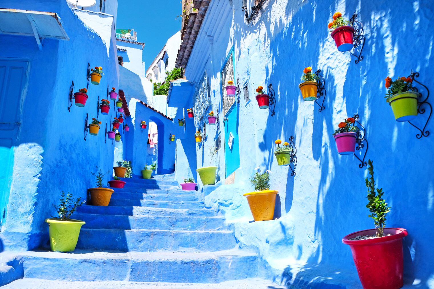 Une rue de la ville de Chefchaouen avec les murs et les escaliers bleus