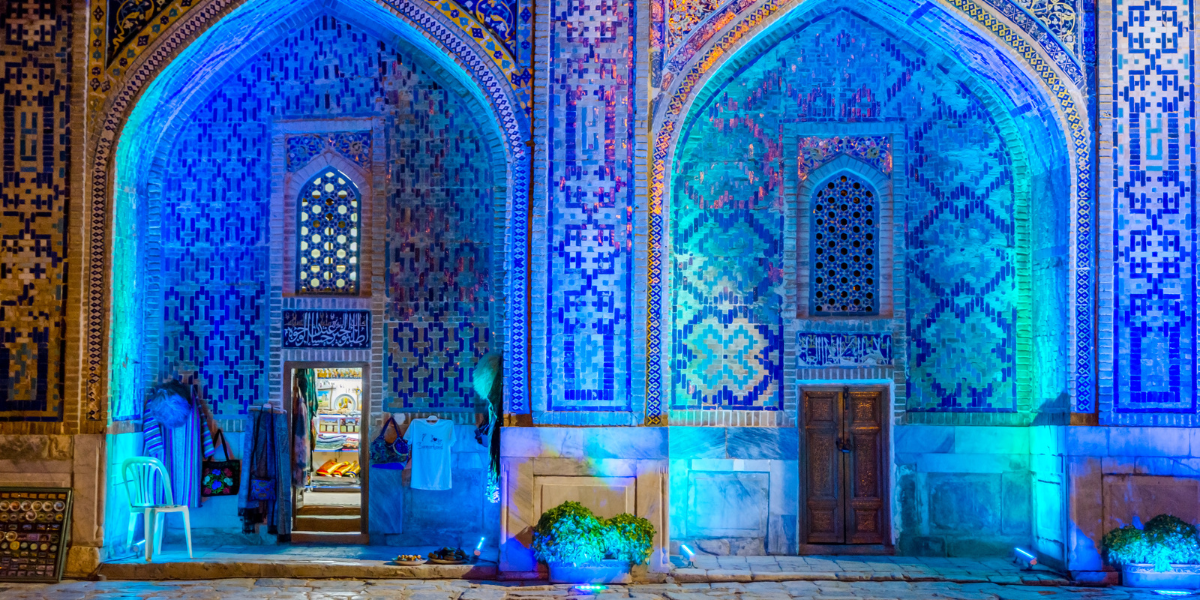 Shopping dans l'atrium éclairé de Sher Dor madrasah la nuit, Registan, Samarcande